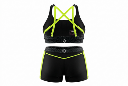 A two-piece athletic set consisting of a sports bra and matching shorts in black with bright neon yellow-green trim and straps, shown on a plain white background.